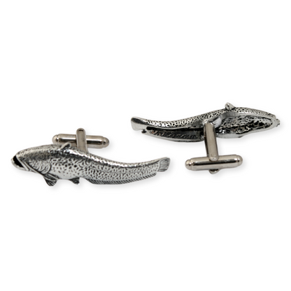 Silver fish-shaped cufflinks on a white background