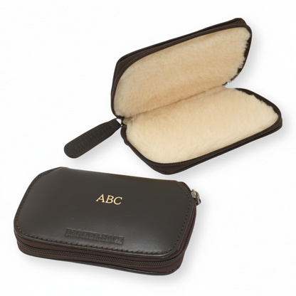 Brown leather fiishing fly case with open interior showing beige lining